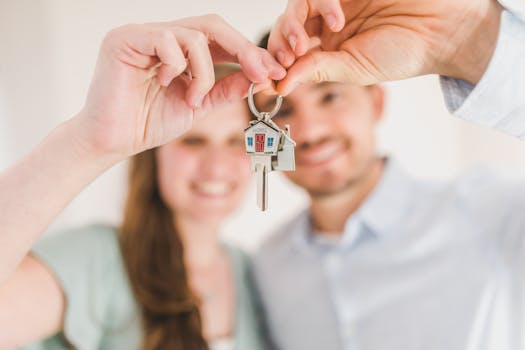 pexels-photo-8293700-8293700 Young couple holding keys to their new home, symbolizing a fresh start and investment in real estate.